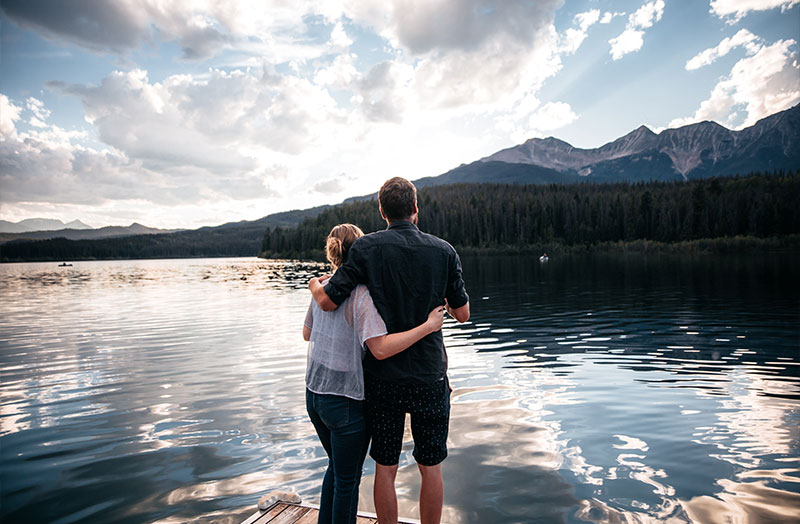 A couple contemplating the lake view